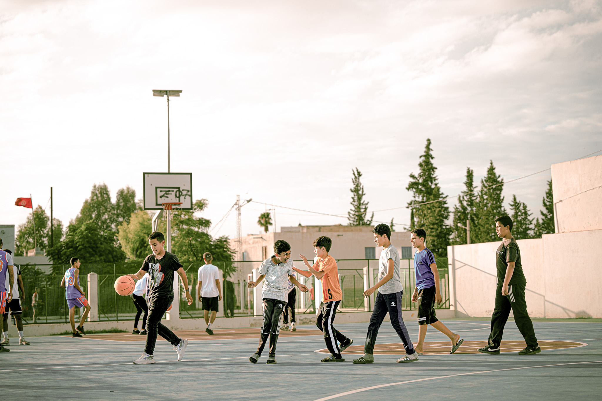 Youth playing basketball in community